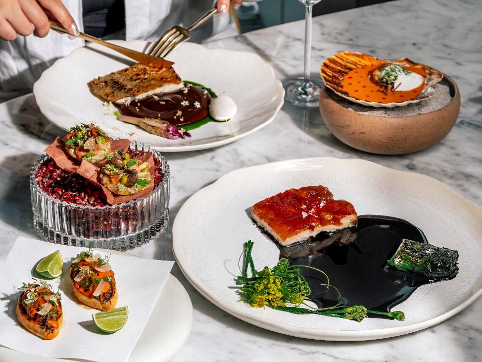 A table with plates of food AI-generated content may be incorrect.